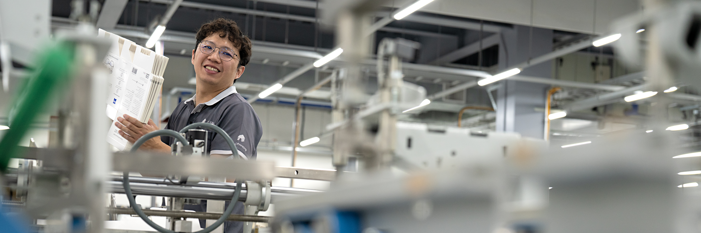 NTI technician handling freshly printed sheets